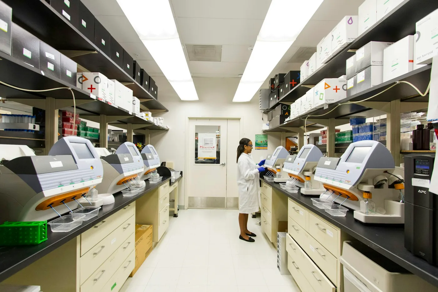Professional pathology lab technician using microscope